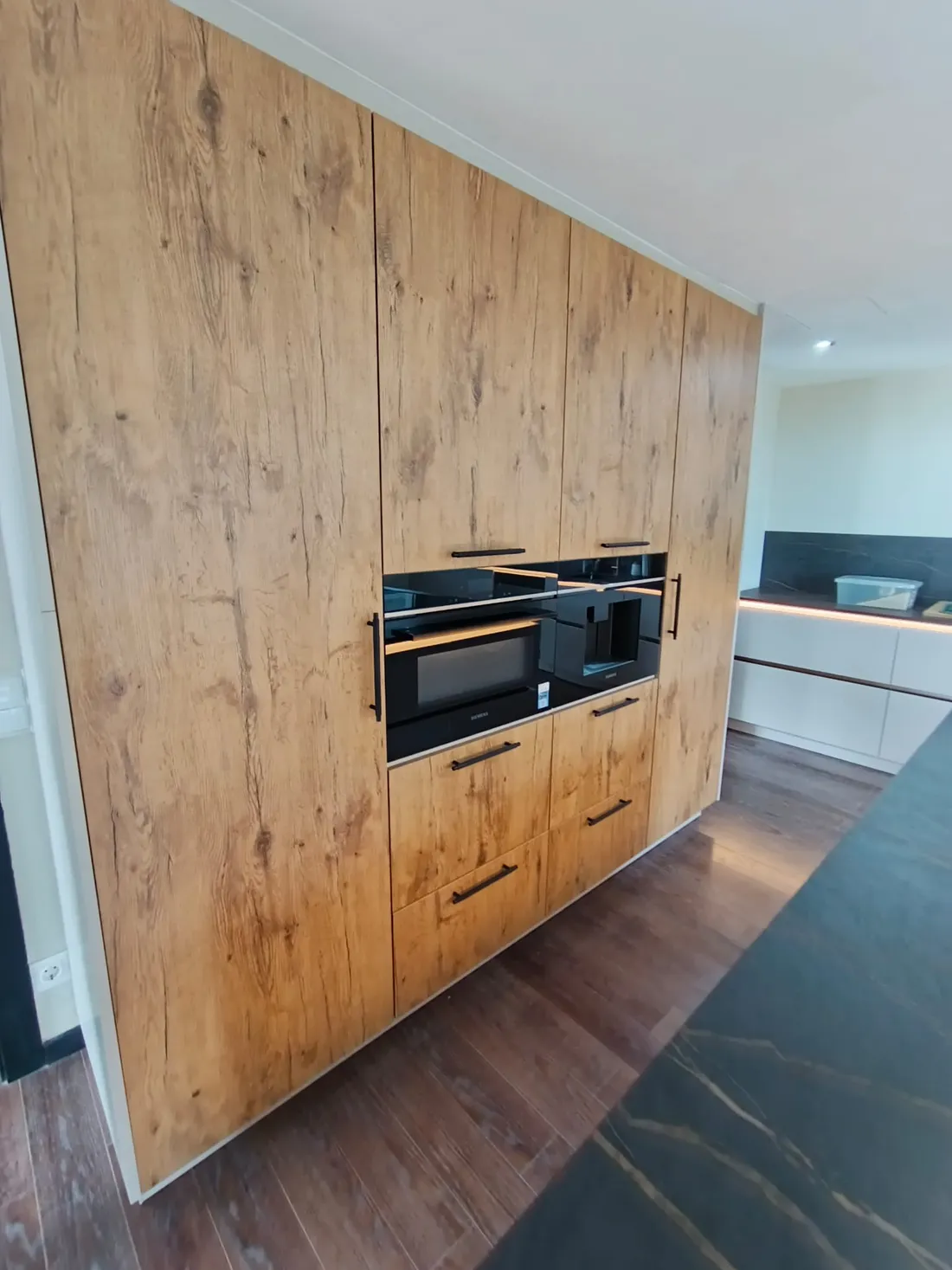 Columna de armario en madera roble con electrodomésticos integrados montada por Montajes Aguilar